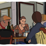Un groupe de personnes assises autour d'une table dans un café.