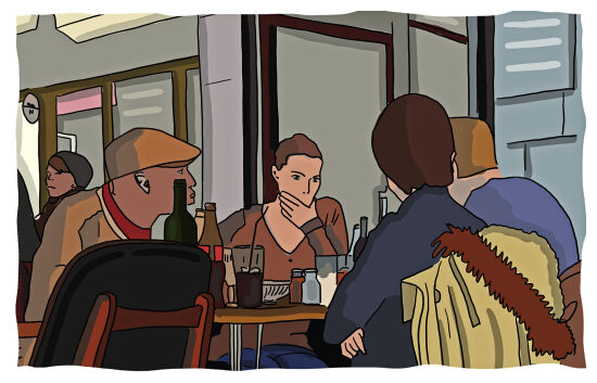 Un groupe de personnes assises autour d'une table dans un café.